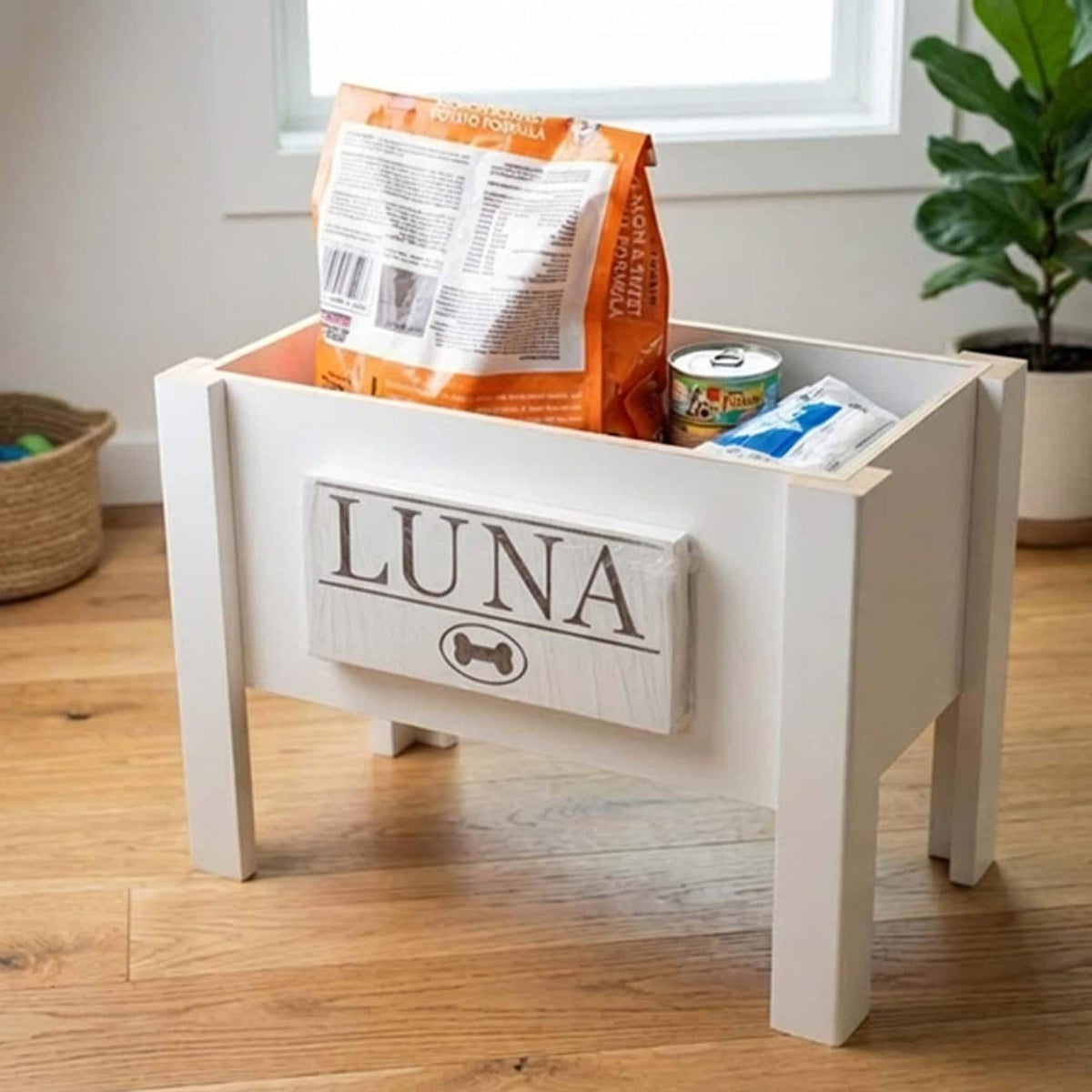 Open personalized elevated dog feeder storage compartment holding a bag of dry dog food and pet supplies