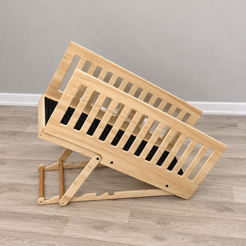 Side view of a natural wood adjustable dog ramp showing the incline support, carpeted walkway and removable rails
